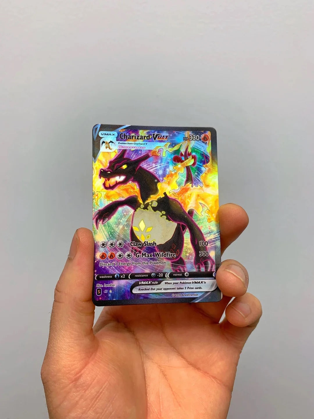 Holding the original 2020 custom Charizard card