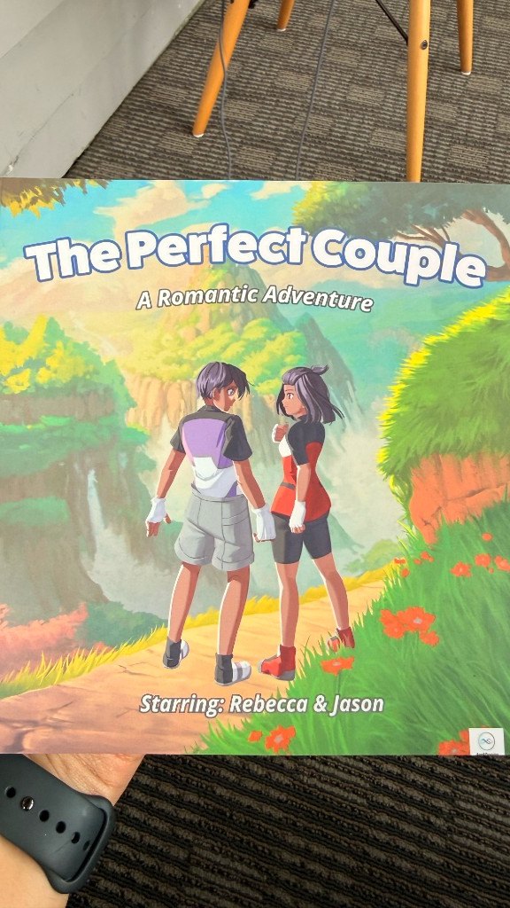 A printed copy of The Perfect Couple, starring Rebecca & Jason, held in hand